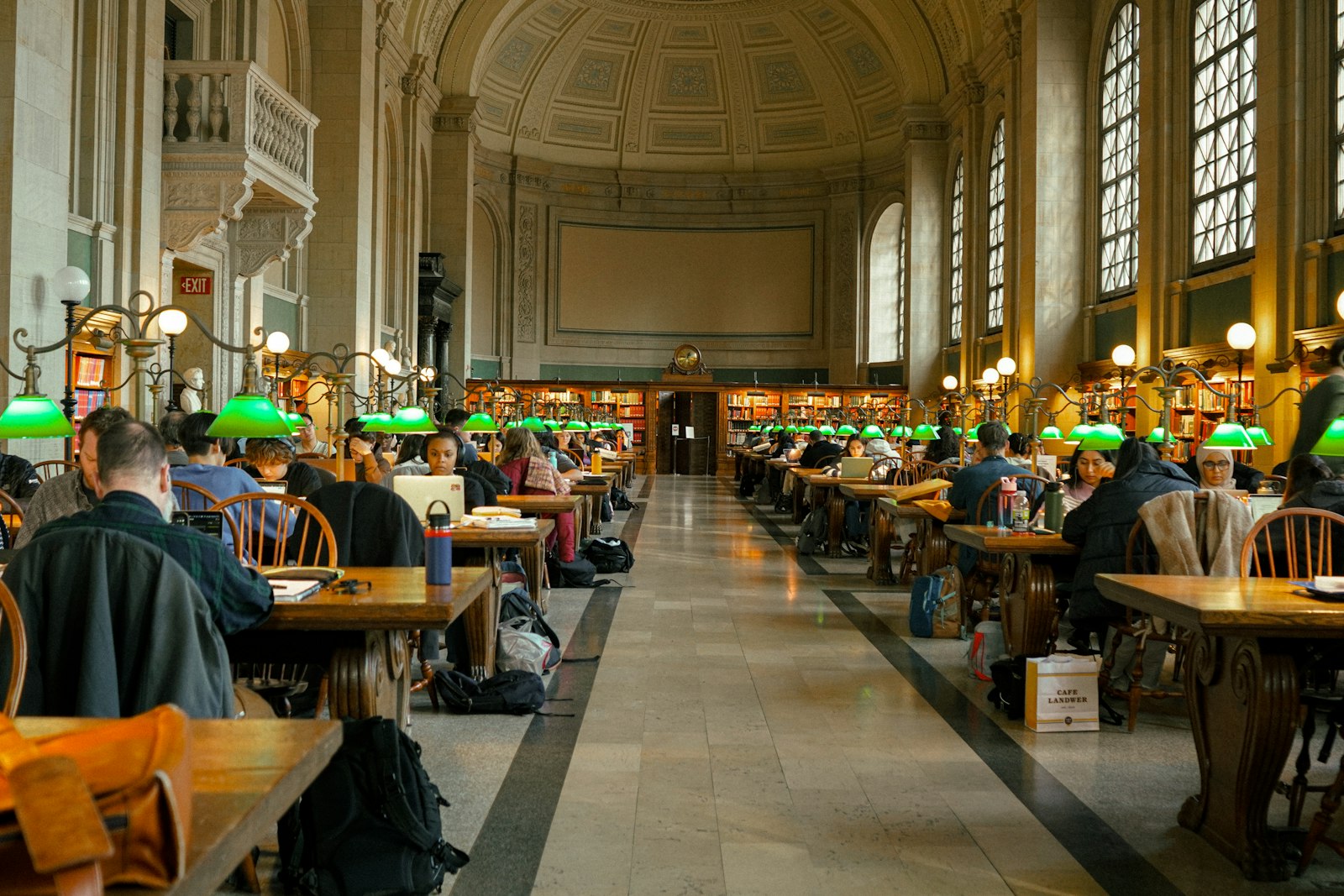 Long tables under the barrel-vaulted ceiling of Bates Hall at the Boston Public Library