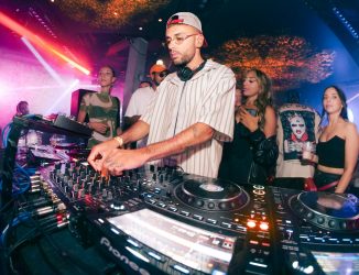 DJ mixing music for a crowd at a corporate holiday party