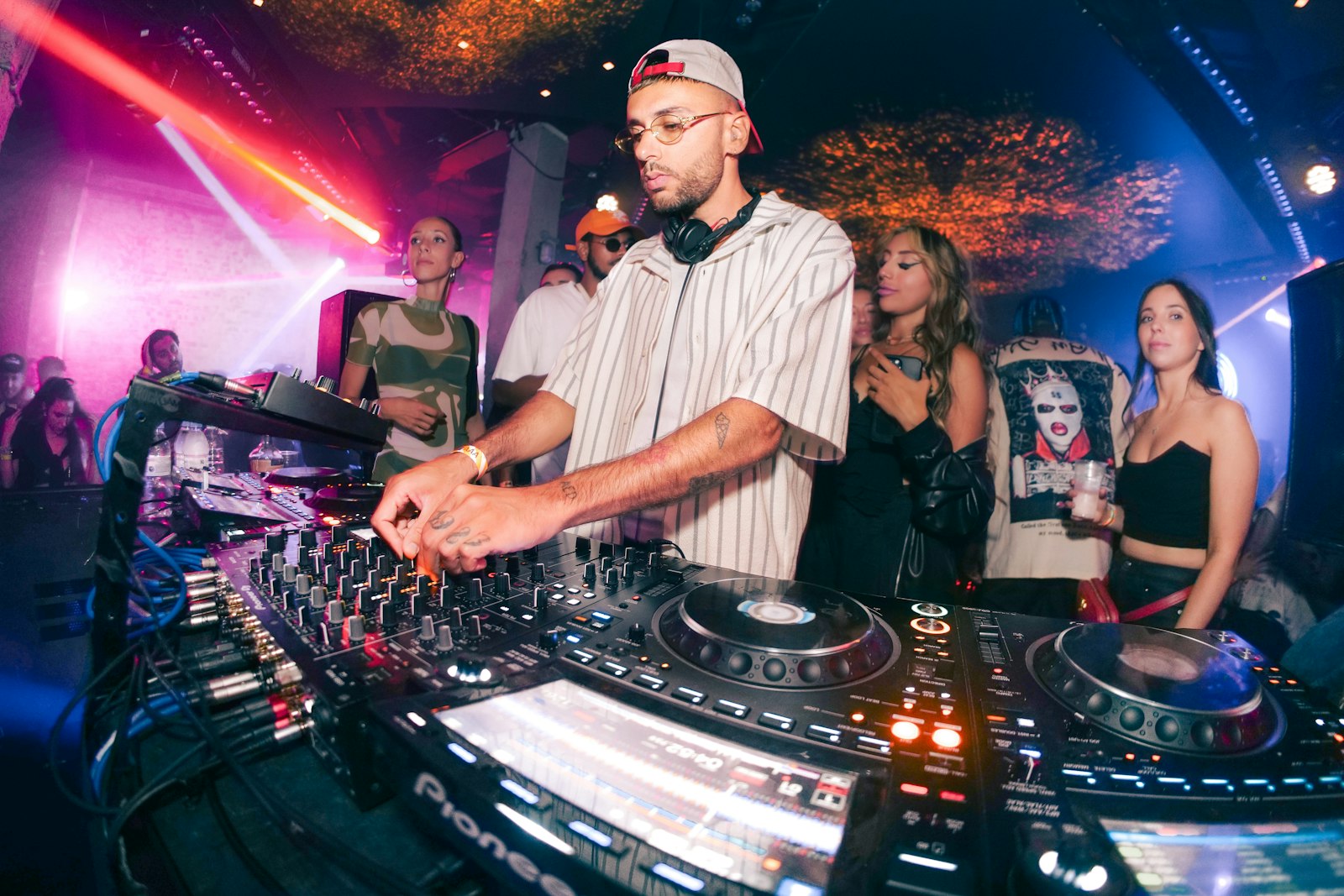 DJ mixing music for a crowd at a corporate holiday party